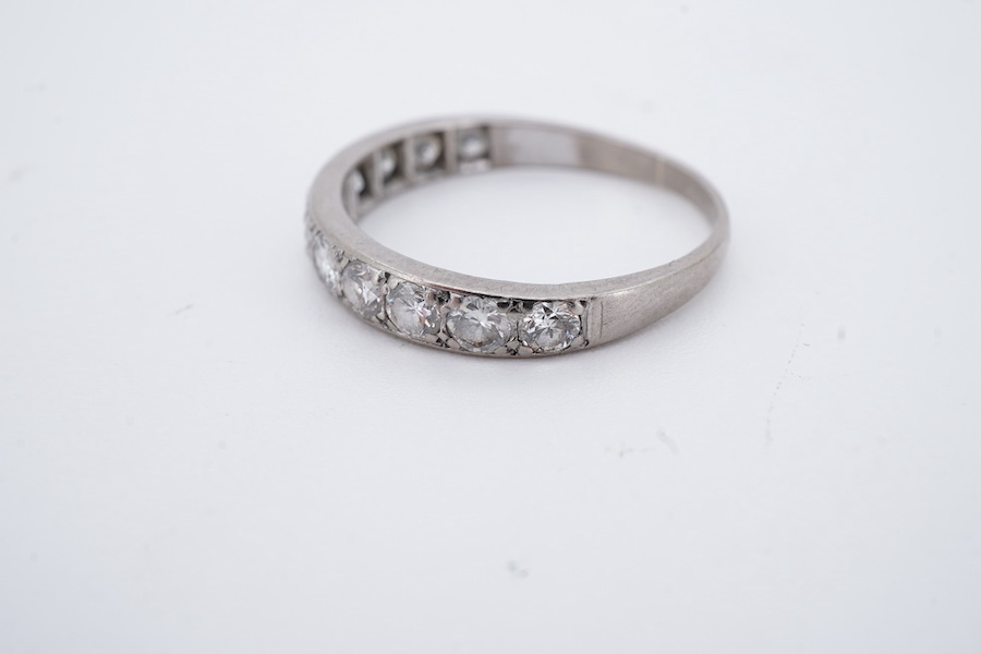 A diamond half eternity ring, set to the front with a sequence of brilliant-cut diamonds totalling approximately 0.80 carats, mounted in white gold, size O1/2, stamped 18CT, gross weight approximately 2.5 grams